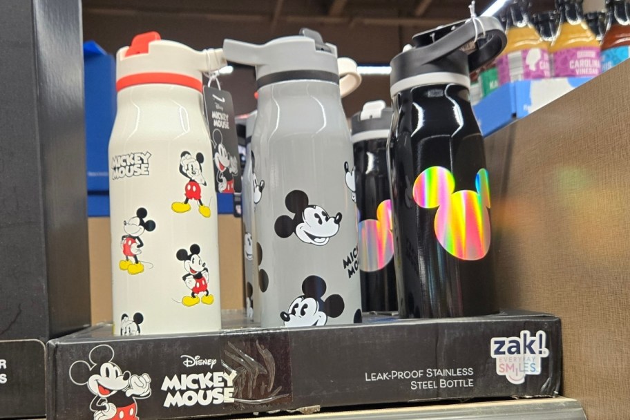 three disney water bottles on a store shelf