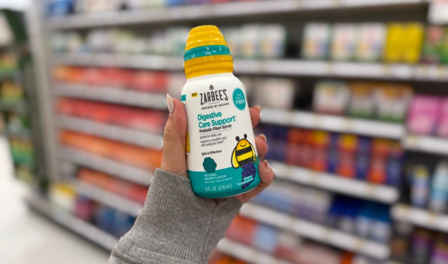 hand holding up a bottle of Zarbees fiber syrup in a store aisle