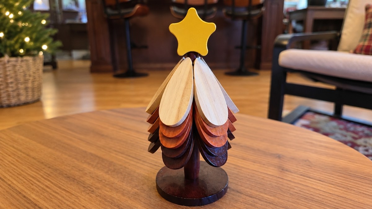 Five-piece Wooden Coaster Trivet Tree set spread out on a dining table protecting the surface from festive dishes
