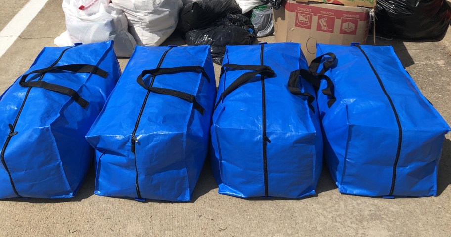 4 blue storage bags in a row
