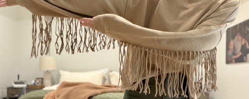 woman wearing Aerie Festival Fringe Crew Sweatshirt in brown color
