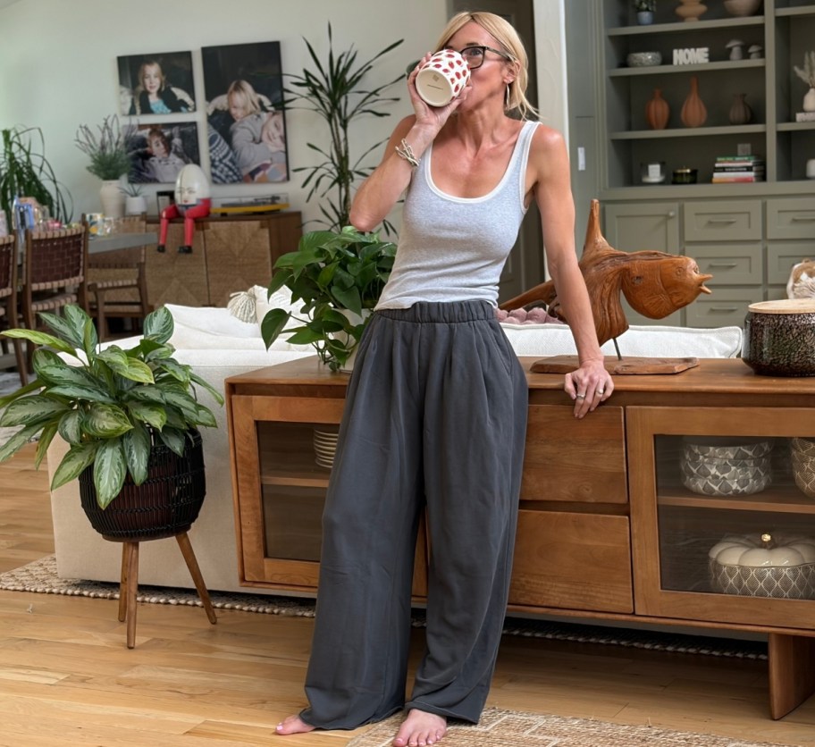 a woman ina pair of gray pants and a ribbed tank top
