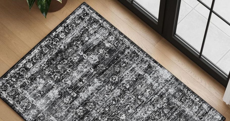 a black and white boho area rug in front of a door