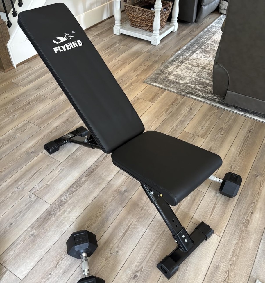 Black workout bench assembled sitting on wood floor in living room 