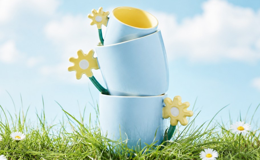 stacked blue mugs with yellow flower handles