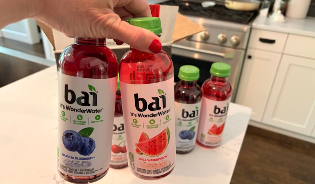 woman holding bottles from Bai Safari Variety Pack in kitchen