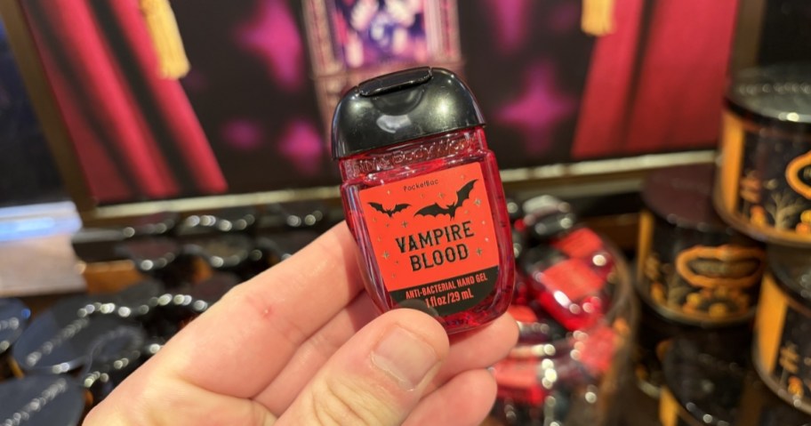 person holding bath & body works pocketbac hand sanitizer bottle in vampire blood scent