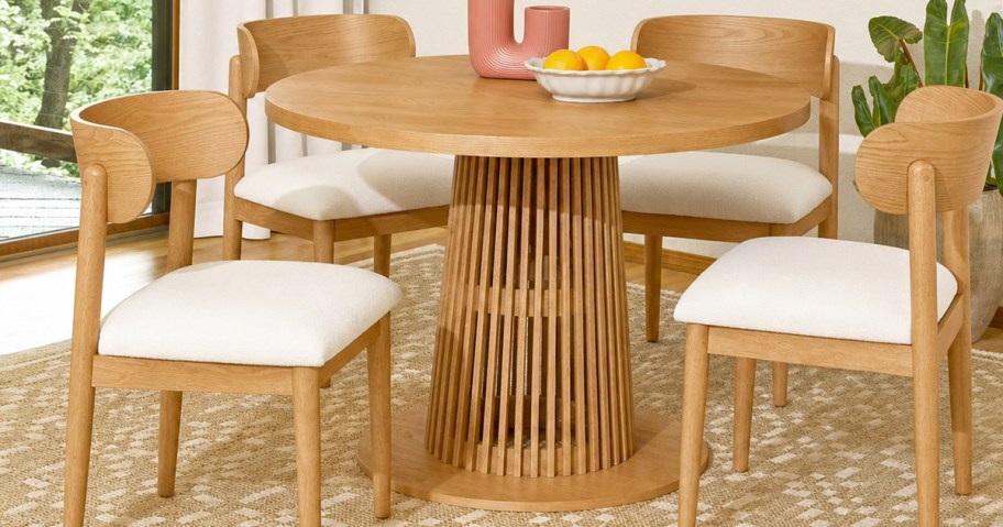wood chairs around a round wood table