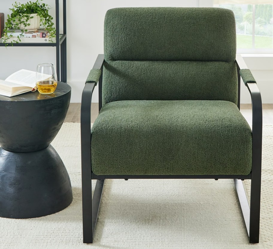 green chair with a black side table