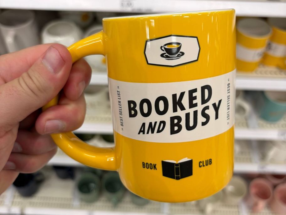 Booked and Busy Mug in hand in store
