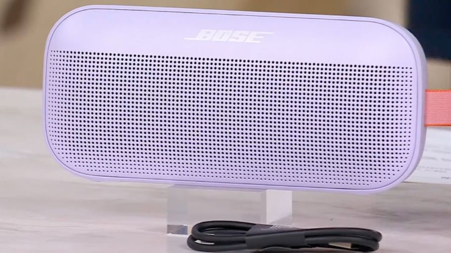 purple bose speaker on top of the table