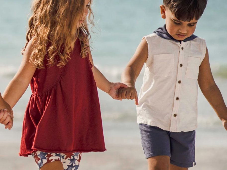 twi kids at the beach wearing burt's bees clothing