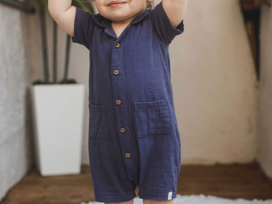 Little boy wearing a Burt's bees gauze baby romper