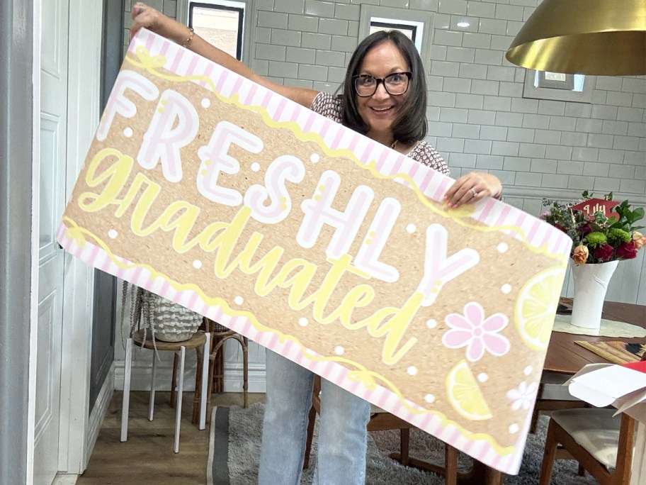 woman holding up a custom photo banner