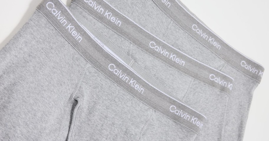 three pairs of gray Calvin Klein boxers 