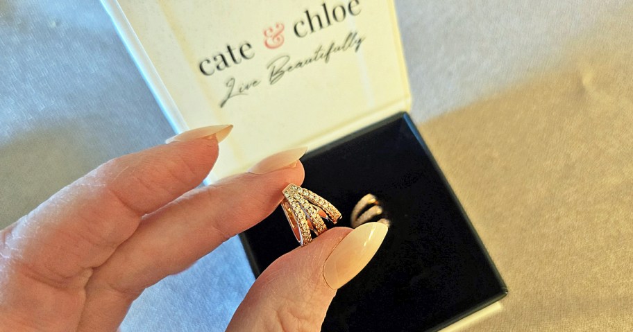 hand holding a silver earring