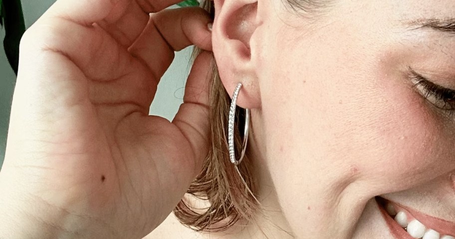 woman wearing silver hoop earrings