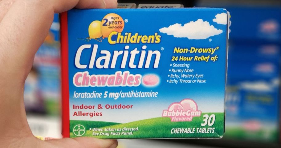 Hand holding a box of children's Claritin