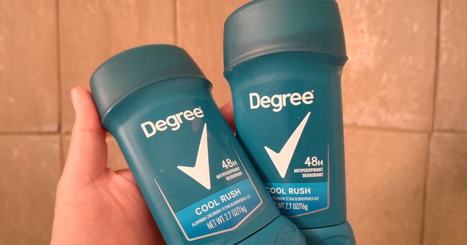 hand holding two Degree deodorants