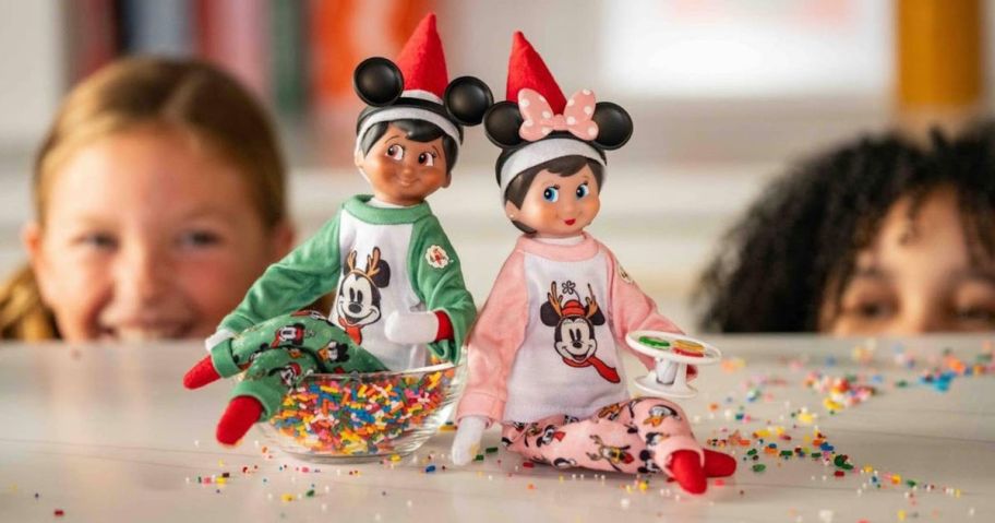 mickey and minnie mouse Disney x Elf on the Shelf Collection on table with kids peeking at them