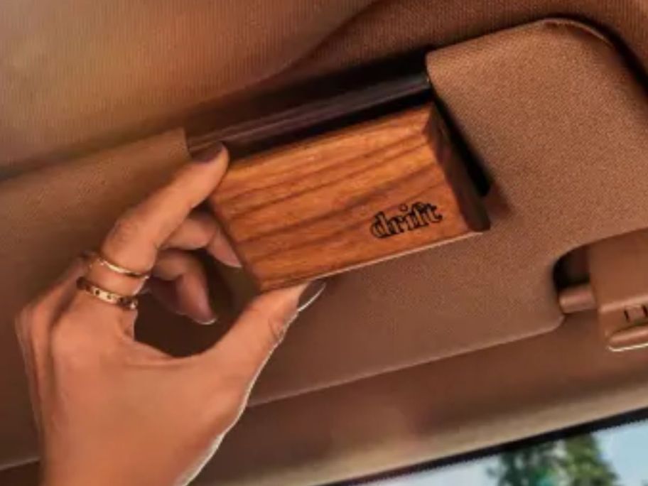 hand touching Drift Wood Car Freshener Starter Kit