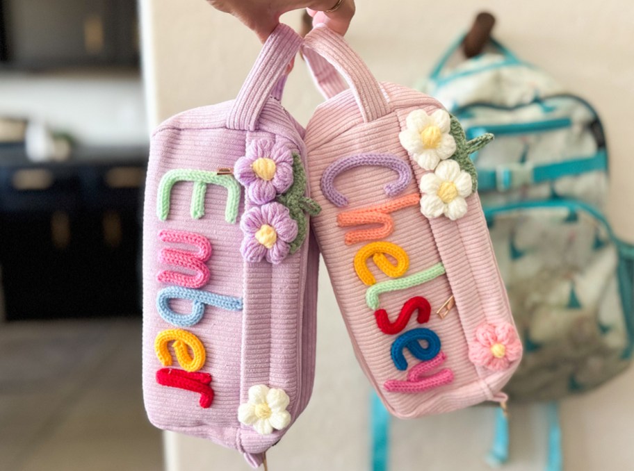 person holding two custom pencil cases
