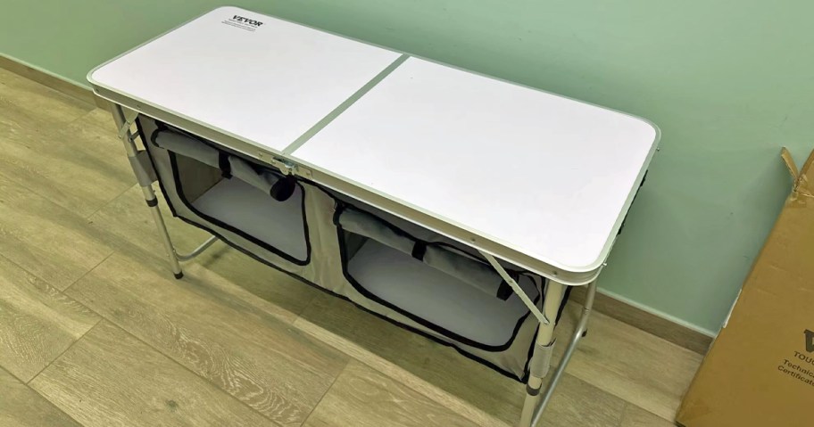 white folding table with storage compartment underneath it