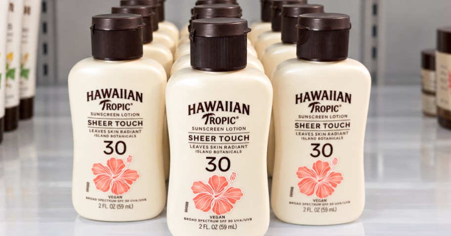 mini bottles of Hawaiian Tropic Sunscreen in a row on a shelf