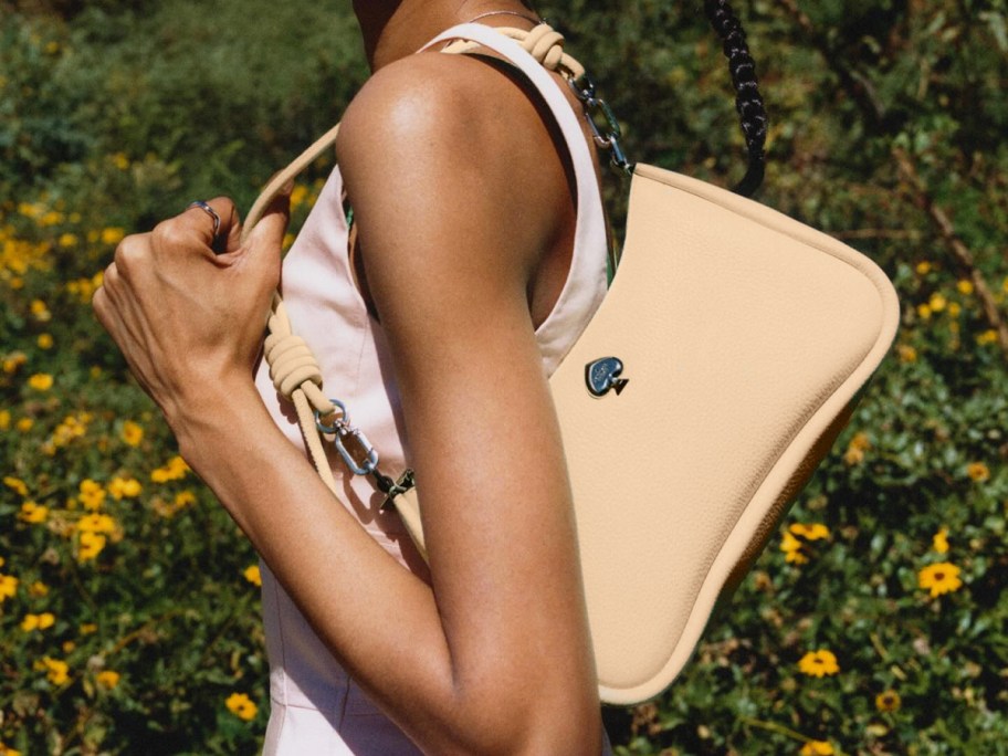woman carrying a small orange shoulder bag