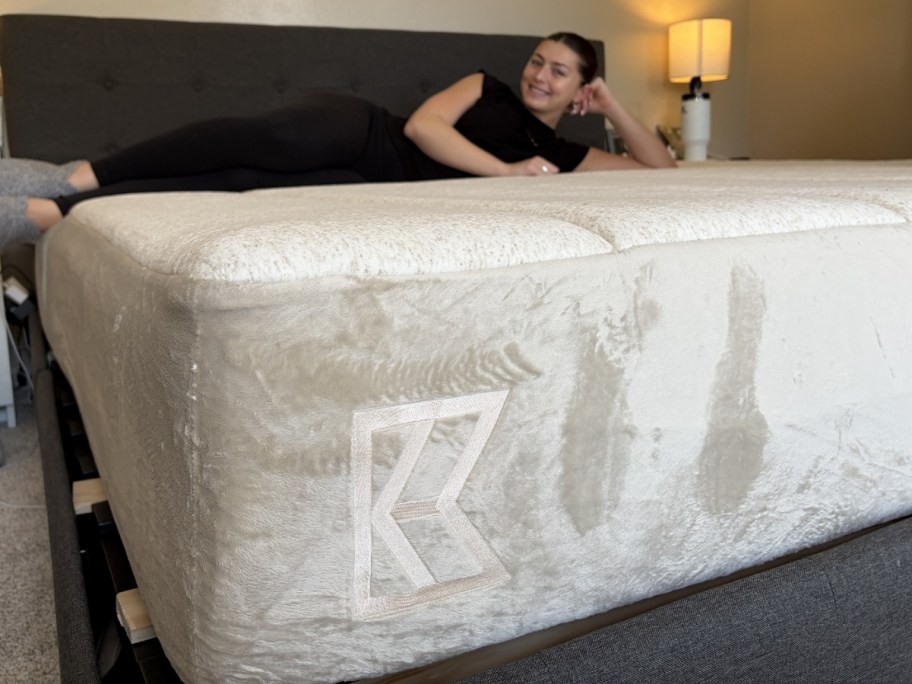 woman laying on a keetsa brand mattress in bedroom