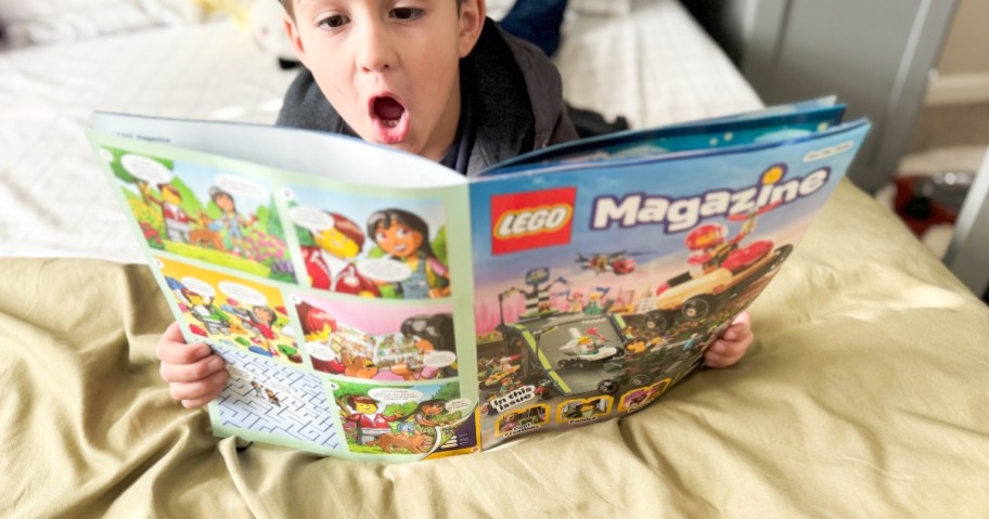 a little boy looking at LEGO Magazine