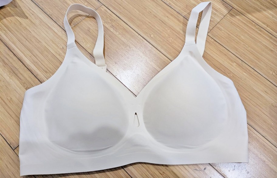 white bra laying on wood floor