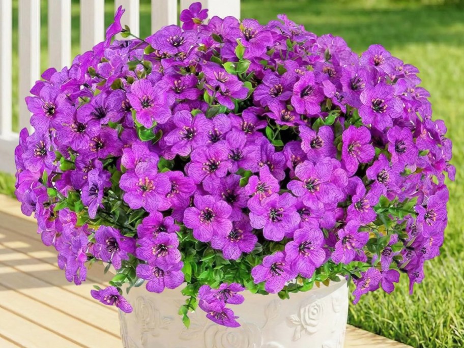 bright purple artificial flowers in a planter