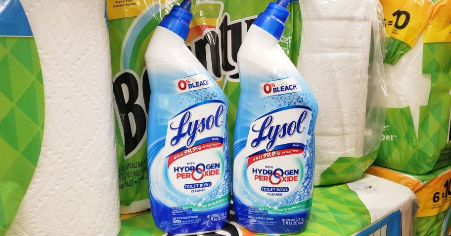 two bottles of Lysol Toilet Bowl Cleaner near packs of paper towels