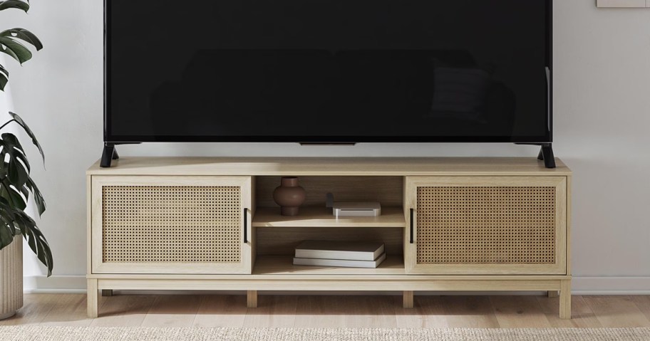 tv on a small cane tv stand in living room