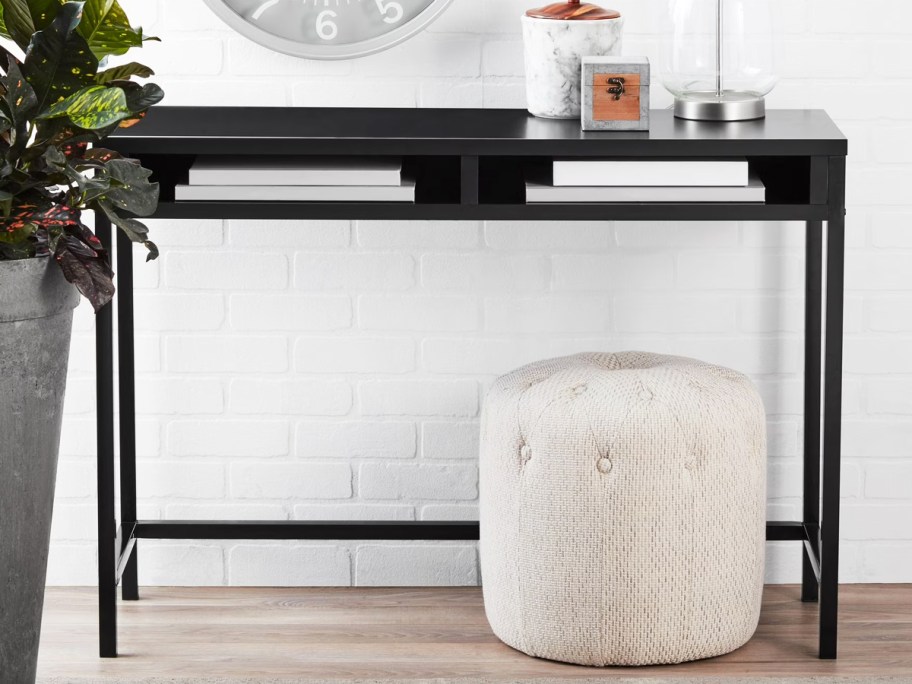 black desk with a white ottoman under it