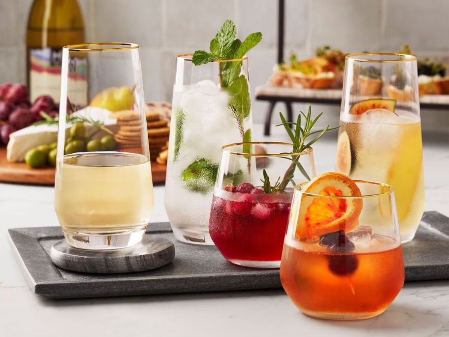 Member's Mark 12-Piece Modern Gold Rim Crystal Drinkware Set with drinks in them