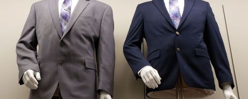 Mannequins wearing suit jackets and dress shirts with ties