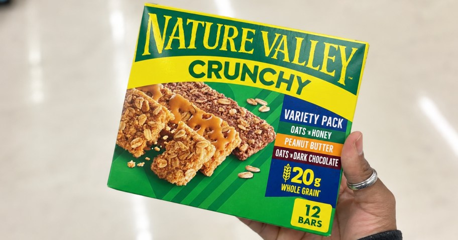 hand holding a green box of Nature Valley Crunchy Granola Bars