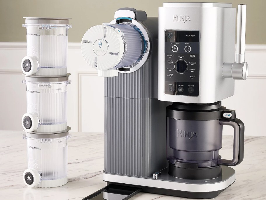 Ninja Swirl machine on counter with a stack of extra pints