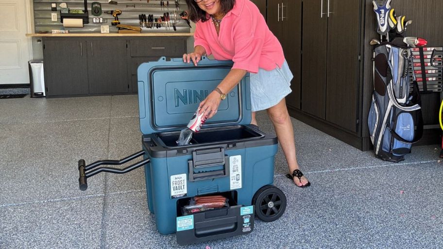 woman holding a Ninja cooler with soda