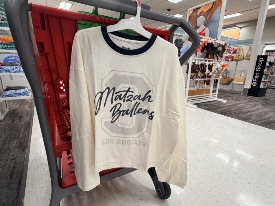Nobody Wants This Women's Matzah Ballers T-Shirt hanging on cart in store