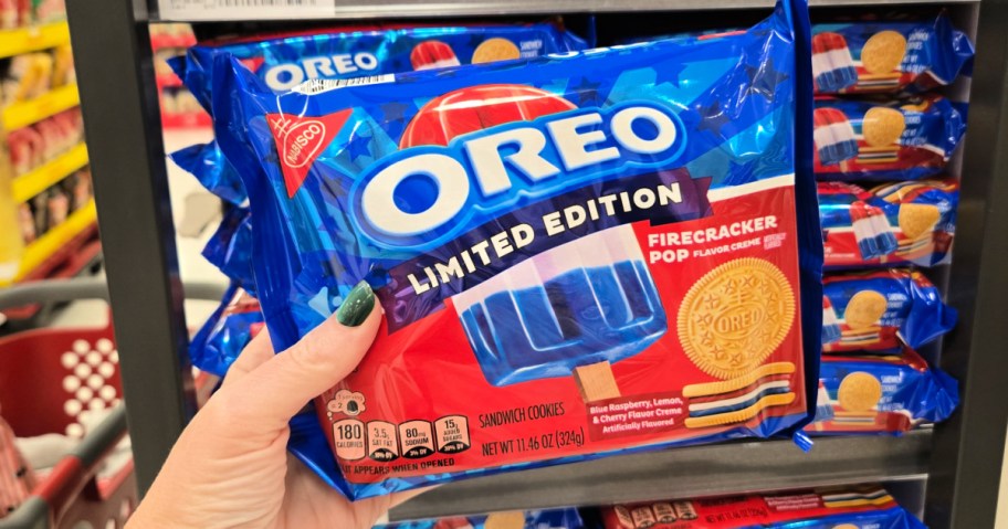 Hand holding up box of Oreo Limited, edition, firecracker cookies