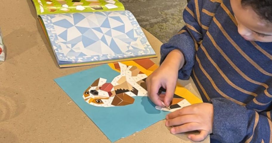 Kid using a Paint by sticker book