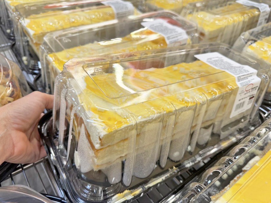 hand grabbing Peaches & Cream Bar Cake