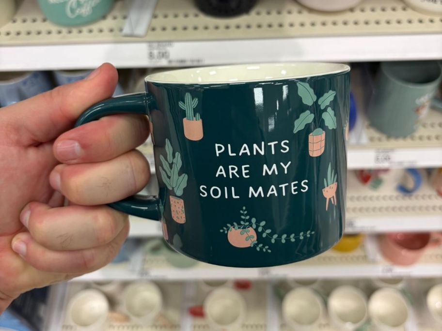 Plants Are My Soil Mates Mug mig in hand in store