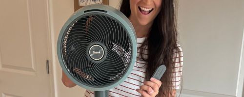 Alli holding Shark FlexBreeze Indoor/Outdoor Cordless Fan and remote