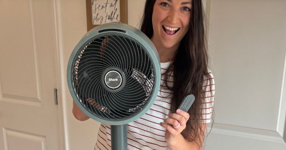 Alli holding the Shark FlexBreeze indoor/outdoor wireless fan and remote control.