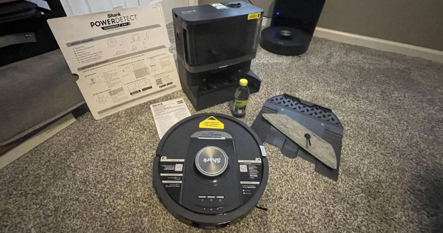 A Shark robot vacuum on a carpet 