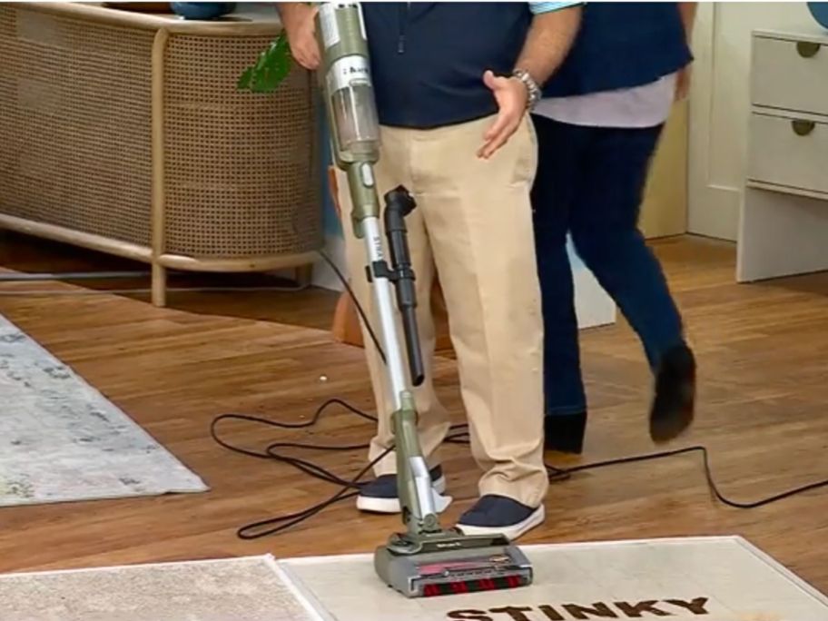 man demonstrating a Shark Stratos Corded Stick Vacuum on HSN